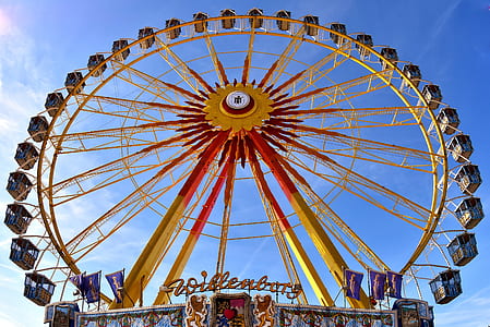 yellow and red Ferris wheel during daytime thumbnail