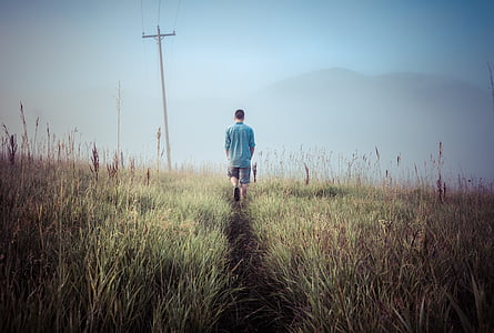 man walks on green grass field thumbnail