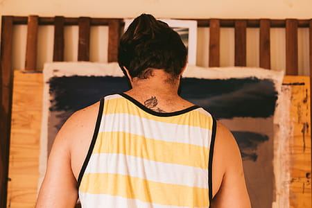 Man Wearing Yellow and White Tank Top thumbnail