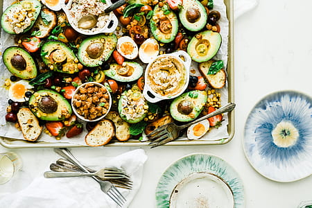 avocado salad in gray platter beside stainless steel forks thumbnail