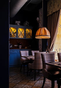 brown turned off pendant lamp near dining set in room thumbnail