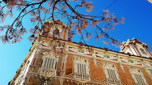 low angle photography of brown cathedral under blue sky background thumbnail