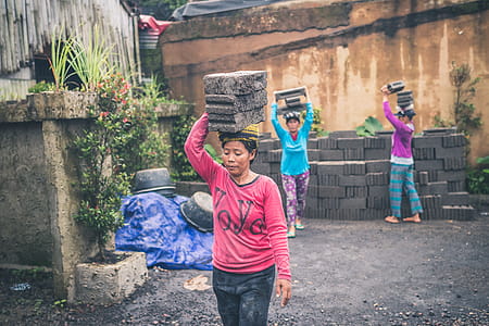 Photography of People Carrying Cinder Blocks thumbnail