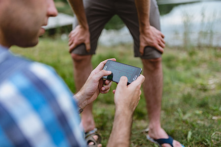 Closeup of man hands playing videogames on cell phone thumbnail