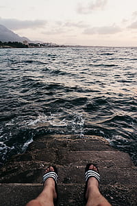 person sitting on sea dock thumbnail