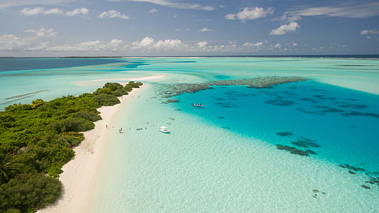 aerial photo of bodies of water near island at daytime thumbnail