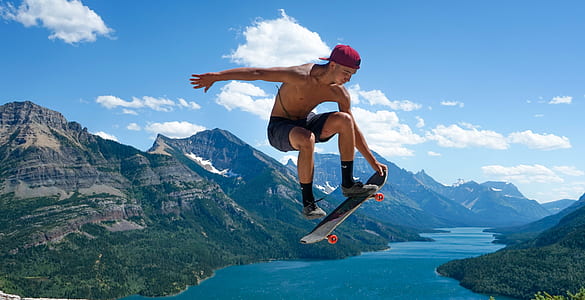 skater doing stunts on air with mountains as background thumbnail