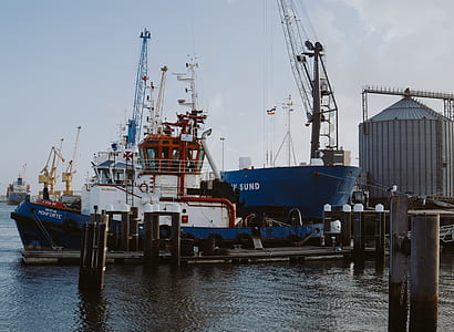 blue and white sailship at pier thumbnail