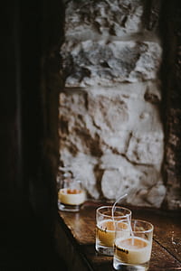 two brown pillar candles on brown wooden table thumbnail