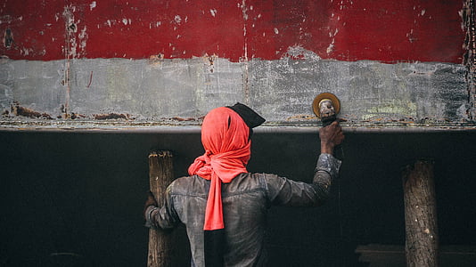 man sanding the wall during daytime thumbnail