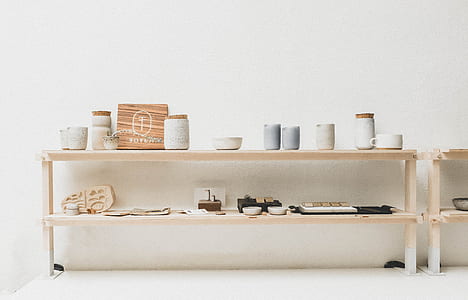 assorted ceramic jars on brown wooden rack thumbnail
