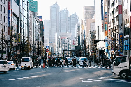 people walking near concrete buildings during daytime thumbnail