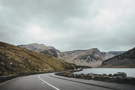empty road near body of water thumbnail
