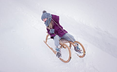 person riding brown wooden sled thumbnail