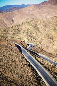 aerial photo of gray road and brown mountains thumbnail