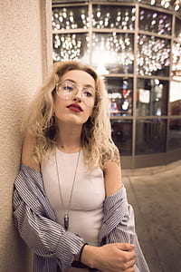 woman leaning on beige wall thumbnail