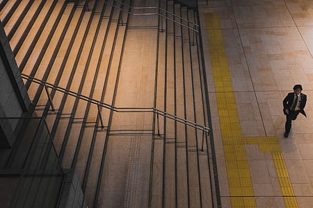 person walking near brown concrete stairs thumbnail