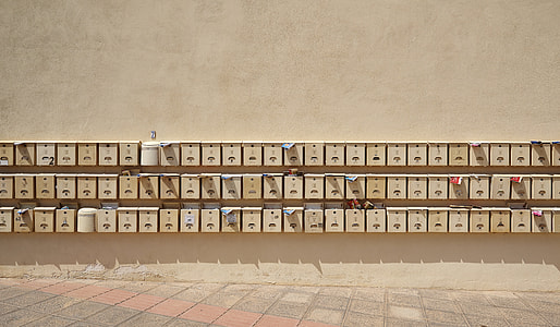 piled brown wall-mount mailboxes thumbnail