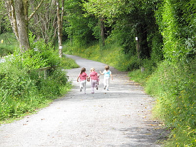 three girls running on road during daytime thumbnail
