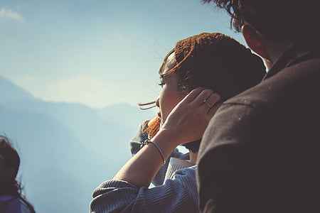 woman standing near man taken at daytime thumbnail
