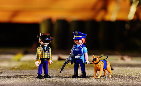 shallow focus photography of cowboy and policewoman mini figures thumbnail