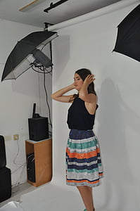 woman wearing blue sleeveless shirt and multicolored skirt thumbnail