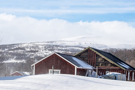 brown wooden house coated snow under white sky thumbnail