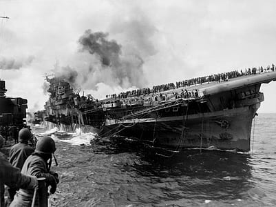 grayscale photography of aircraft carrier about to sink thumbnail