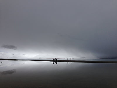 people standing beside body of water thumbnail