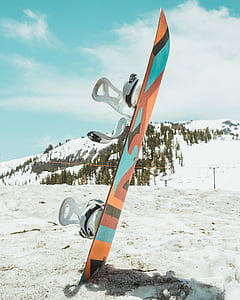 orange and teal snowboard with bindings thumbnail
