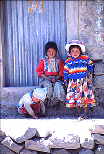 two girls and one boy leaning on concrete wall thumbnail