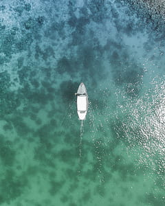 aerial photography of white boat in the middle of the sea at daytime thumbnail