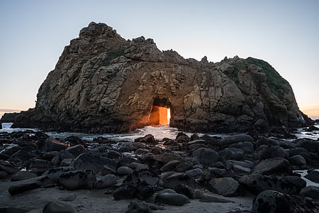 landscape photo of gray rock formation near body of water during daytime thumbnail
