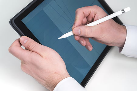 person writing in a tablet computer using stylus thumbnail