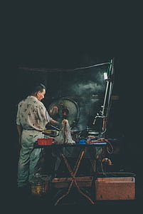 man grilling in front of electric fan thumbnail