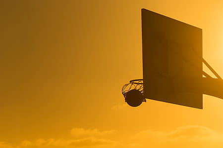 photography of silhouette of basketball board during daytime thumbnail