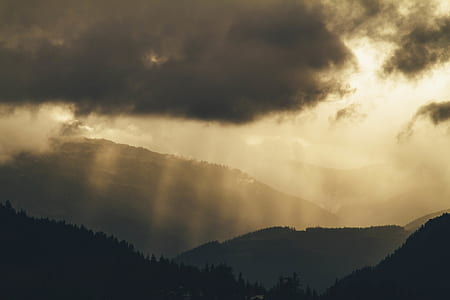 sun rays beaming on mountains thumbnail