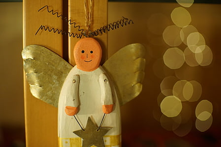 white and orange wooden angel figurine thumbnail