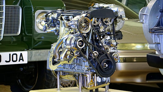 silver vehicle engine beside green vehicle thumbnail