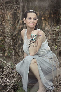 woman surrounded by plants posing for photo thumbnail