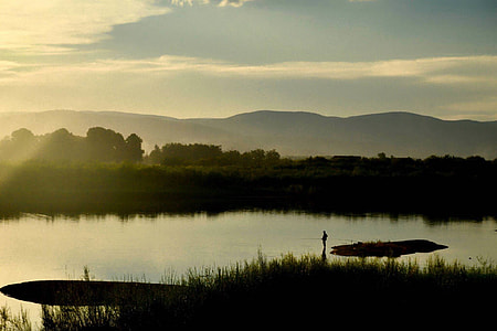 landscape photography of river overlooking mountain range under clear sky during daytime thumbnail
