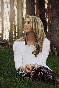 woman sits on green grass field under the tree thumbnail