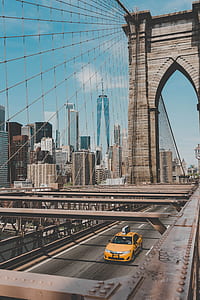 yellow taxi on Brooklyn Bridge thumbnail