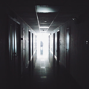 person in middle of hallway behind the light thumbnail