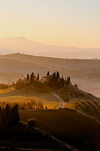 photo of concrete house near plain fields during golden hour thumbnail