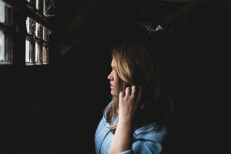 woman in blue dress shirt near window glass thumbnail