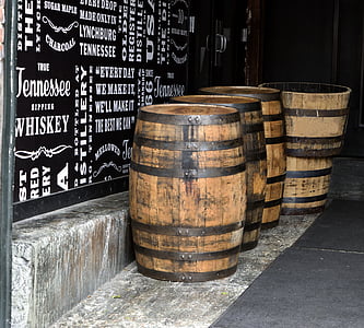 four brown beer barrel on floor beside black wall thumbnail