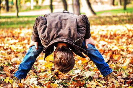 photo of boy looking between legs thumbnail