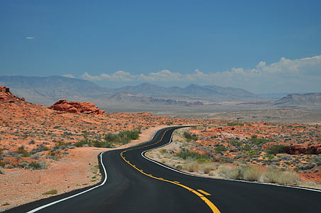 asphalt road in middle of land thumbnail