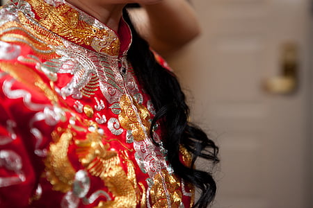 woman wearing red, brown, and gray floral top thumbnail